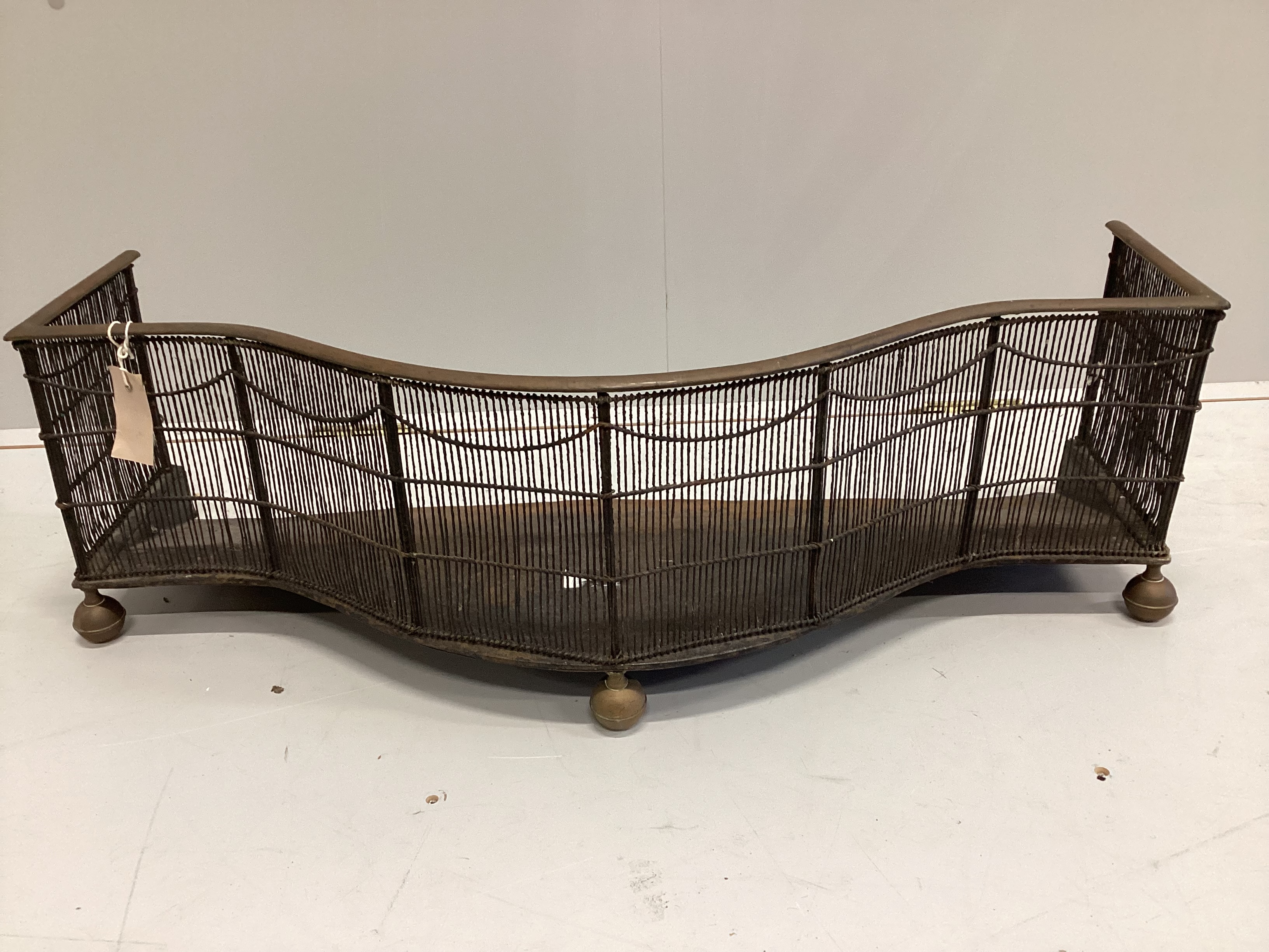 A George III bowfront brass mounted wirework fender, width 88cm, depth 35cm, height 26cm